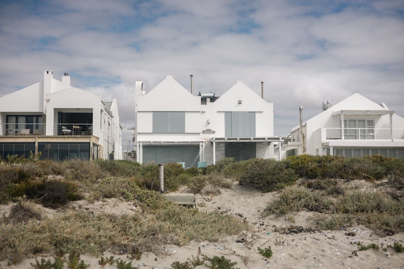 White beachfront homes behind the dunes on Amelia Island, closed up while the owners are away for the season